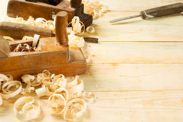 Carpenter tools on wood table background with sawdust. Copy space