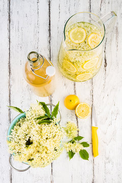 Elderflower and lemon slices in a jar. Ingredients for making elderflower syrup.