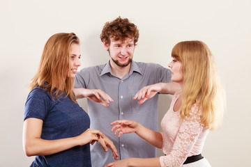 Aggressive mad women fighting over man.