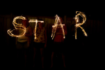 The word Star in sparklers time lapse photography