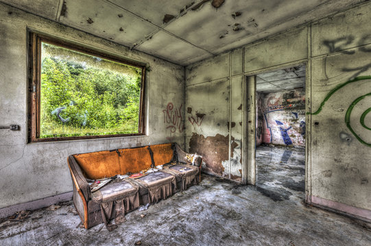 Rotten sofa in an abandoned room