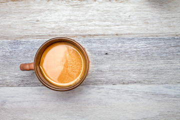 Cup of coffee on wooden background