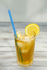 Yellow lemonade in a glass on table close-up