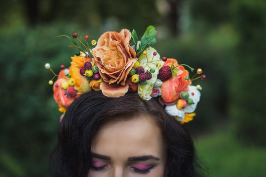 Attractive young woman with orange flowers crown