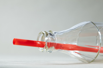 Empty soda bottle and straw
