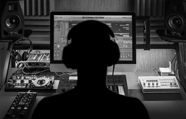 Foto op Aluminium Man produce electronic music in project home studio. Silhouette. Black and white photo. © evgenydrablenkov
