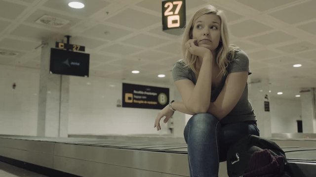 Young Adult Female waiting for luggage in airport