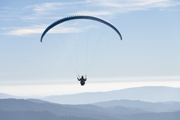 Paragliding flying in the sky.