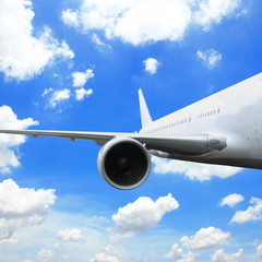 Large passenger plane flying in the blue sky