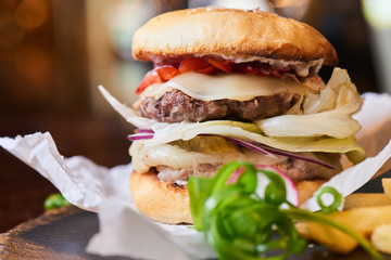 Fast food dinner of Burger and fries, served on a stone Board