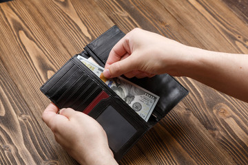 Black man's wallet in man hands