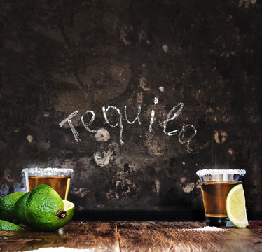 Tequila shots with lime slice.