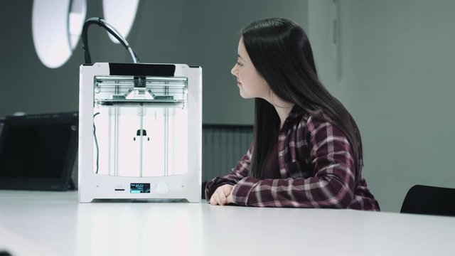 Portrait of girl learning about 3d printer at school