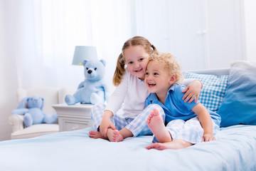 Kids playing in white bedroom