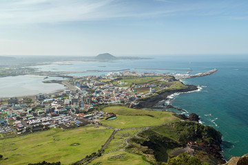 View of Seongsan-ri city and coastline from Seongsan Ilchulbong Peak on Jeju Island in South Korea.