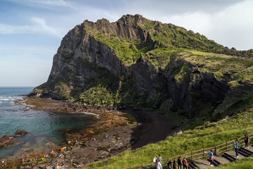 View of people at the Seongsan Ilchulbong ("Sunrise Peak"), archetypal tuff cone, on Jeju Island in South Korea.