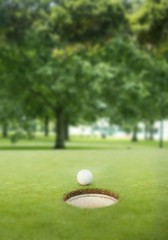 Golf ball at the edge of the hole