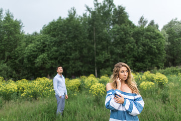 Obraz premium happy young couple man and woman walking in nature