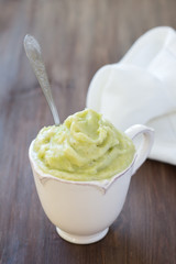 Rhubarb banana sorbet in cup on a wooden table, selective focus