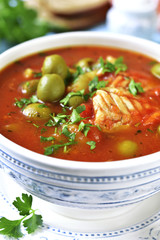 Tomato soup with cod,potato and olives.