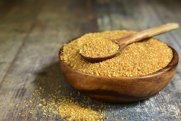 Brown sugar in a wooden bowl.
