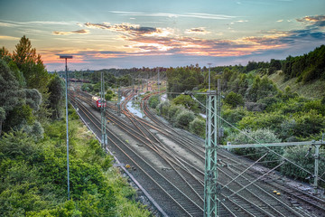 Railway Station at Sunset.
Crossing railroads with evening sky. Munich,Germany