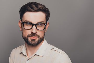 Portrait of smart young handsome bearded man in glasses