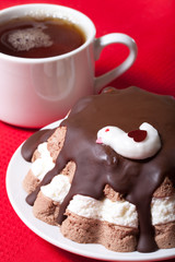 Homemade cake with bird decor on red tablecloth for background.