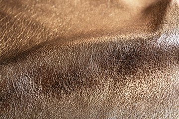 Dark brown shiny leather texture close up