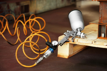 Spray gun on wooden stand, closeup