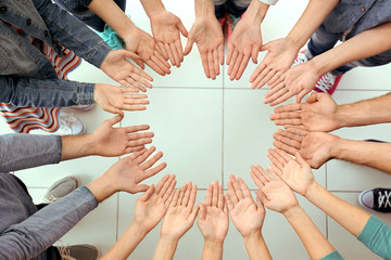 Teamwork concept. United hands, top view