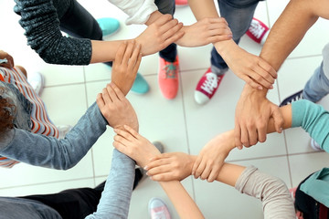 Teamwork concept. United hands, top view