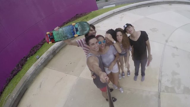 Friends standing on street and taking selfie  having fun