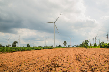 Wind turbines generate electricity at field all agriculture plantation in thailand