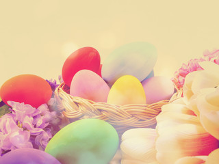 Obraz na płótnie Canvas colorful easter eggs with spring flowers background vintage filter color