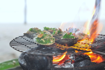 Grilling shellfish and seafood on hot fire