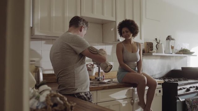Couple in kitchen having coffee in the morning