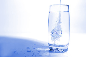 water pouring in transparent glass with bubbles of air