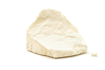 solid block of powdered milk on white