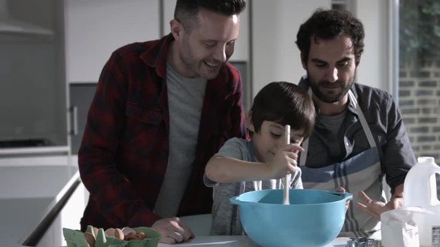 Same sex couple family cooking biscuits