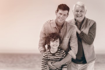 Male family members posing at the beach