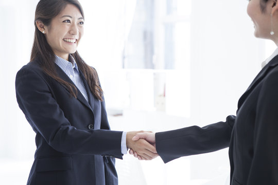 Business women are shaking hands in the office