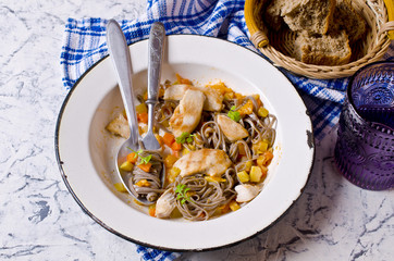 Dark pasta with vegetables and chicken.