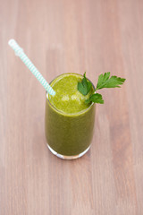 Fototapeta premium Green healthy smoothie with spinach, green apple and celery. Sepia toning. Shallow dof