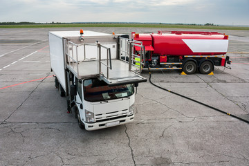 Airport catering truck and refueling truck on apron