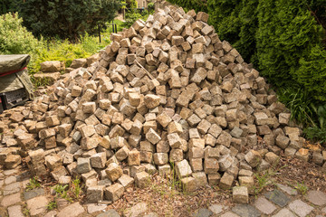 pile of paving stones made of granite, used Pavement brick pile laying in chaos