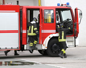 Fototapeta premium fire engine with many firefighters and equipment for fighting fi