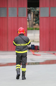 Firefighters in uniform with red helmet