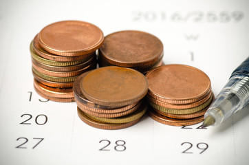 Financial planning,business concept (coin,calendar and pen)