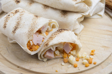 Breakfast burrito with eggs, cheddar, microgreens and roasted mu